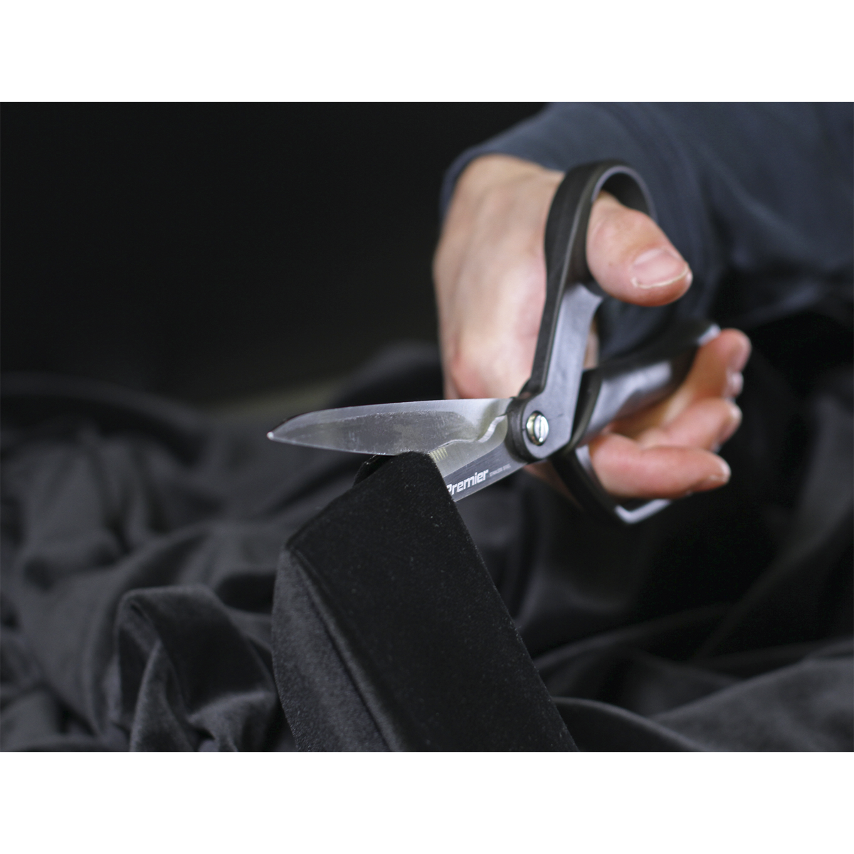 The Sealey Shears/Scissors 250mm Heavy-Duty - AK8524 with ergonomic handles effortlessly cut through black fabric.