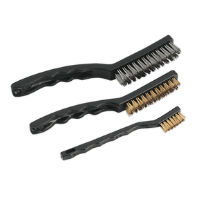 Displayed side by side are three wire brushes from the Sealey Wire Brush Set Auto Engineer's 3pc - AK9801, each featuring composite handles and different bristle materials: one with steel-filled bristles, one with brass-filled bristles, and another with nylon bristles.