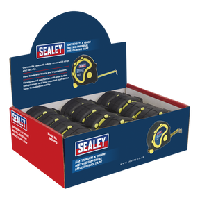 Display box containing 12 Sealey Rubber Tape Measures, each measuring 5 meters (16 feet) by 19 millimeters with both metric and imperial scales. The blue box features Sealey branding and product information, and each tape includes a durable steel blade.