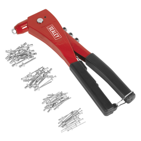 A "Sealey" Hand Riveter Kit - AK99, featuring a red and black tool, is displayed with piles of aluminum rivets and silver chrome steel jaws arranged beside it.