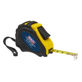 A Sealey Auto Lock Tape Measure 3m(10ft) x 16mm - Metric/Imperial (AK993) with a high-visibility black and yellow composite case, dual Metric and Imperial scales, and a wrist strap; the extending yellow measuring tape is partially pulled out.