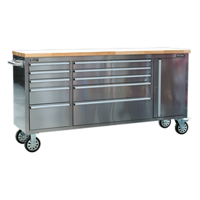 The Sealey Mobile Stainless Steel Tool Cabinet 10 Drawer & Cupboard - AP7210SS boasts a durable stainless steel construction and features multiple drawers for ample storage, including a 10-drawer setup. Complete with a wooden top surface, this versatile piece on wheels doubles as both a stainless steel workbench and an organizational solution.