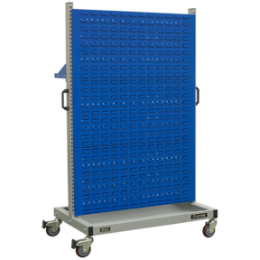 The Sealey Industrial Mobile Storage System with Shelf - APICCOMBO1 features a blue pegboard back with multiple rows of small rectangular holes, four heavy-duty castors, side handles, and a bottom shelf. It is the perfect tool storage solution for any workspace.