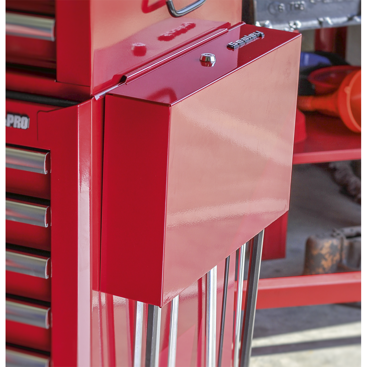 A Sealey red side cabinet for long handle tools (model APLHT) is mounted to the side of a tool chest with multiple drawers in a workshop. This lockable storage unit ensures your breaker bars and pry bars are safely secured.