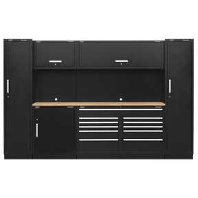 The Sealey Premier 3.3m Storage System - Pressed Wood Worktop - APMSCOMBO7W is a black garage storage solution constructed entirely of steel. It features multiple heavy-duty modular cabinets, drawers with precision ball-bearing slides, and a central wooden work surface. The unit is made of metal and finished with sleek silver handles.