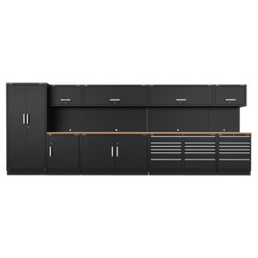 A row of black Heavy-Duty Modular Cabinets from Sealey, known as the Premier 5.6m Storage System - Oak Worktop - APMSOAK, includes two tall cabinets, three wall cabinets, and multiple drawers, all featuring sleek silver handles. These durable units come with a robust oak worktop and a 10-year guarantee.