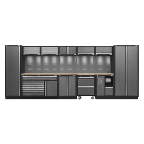 The Superline PRO® 4.9m Storage System by Sealey, model APMSSTACK15W, is a large, modern tool storage solution in dark gray with hammered metal finish accents, featuring multiple cabinets, ball-bearing drawer slide drawers, shelves, and a pegboard.