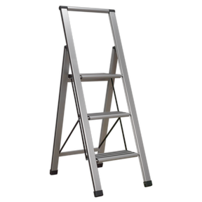 The Sealey Aluminium Professional Folding Step Ladder 3-Step 150kg Capacity - APSL3 features an A-frame configuration with an aluminium frame and anti-slip rubber inserts.