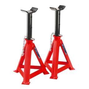 Sealey's Axle Stands (Pair) AS10000, each with a 10-tonne capacity, feature a red and black design with saddle-shaped tops and triangular bases, interconnected by safety chains. These steel stands ensure reliable load support while meeting stringent safety standards.
