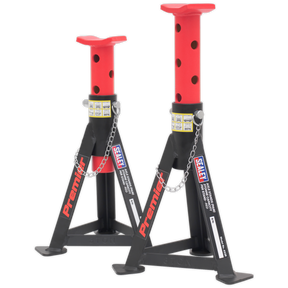 A pair of Sealey axle stands, each with a 3-tonne capacity, in red and black steel, featuring adjustable heights and built for load distribution with welded construction and safety pins.
