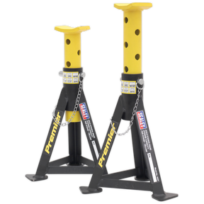 Two yellow steel jack stands with black accents from Sealey, each boasting a 3-tonne capacity and featuring adjustable height settings. These "Axle Stands (Pair) AS3Y" include multi-position pin supports connected by chains for secure load distribution.