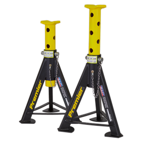 Two heavy-duty Sealey Axle Stands (Pair) with a 6 Tonne capacity per stand, model AS6Y, feature yellow and black polka dot patterns on the top supports, safety chains, and labels. These axle stands boast welded steel construction for enhanced durability.