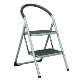 The Sealey Step Stool 2-Tread 150kg Capacity EN14183 - ASL2 is a two-step folding ladder with a gray metal frame and black rubber grip handle. It features EN 14183 approved steps with anti-slip treads and conveniently folds flat for easy storage.