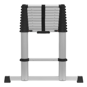 The Sealey Aluminium Telescopic Ladder 11-Tread EN 131 - ATL11, featuring a silver finish with black connectors and a lightweight aluminium frame, is folded and secured with a black strap, standing upright against a white background.