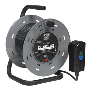 A heavy-duty Sealey Cable Reel 25m (model BCR25RCD) with a black 1.25mm² extension cord wound around it, featuring four 230V plug-in sockets, a handle for carrying, and compliant with BS 7071:1992 standards via its integrated Residual Current Detector (RCD) plug.