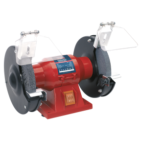 The Sealey Bench Grinder Ø150mm 150W/230V - BG150CX is a compact red bench grinder equipped with aluminous oxide grinding stones, protective shields, and a centrally located on/off switch.