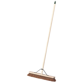 Introducing the Sealey Broom 24" (600mm) Soft Bristle - BM24S, a sturdy wooden push broom with brown bristles and an extended handle, ideal for outdoor use.