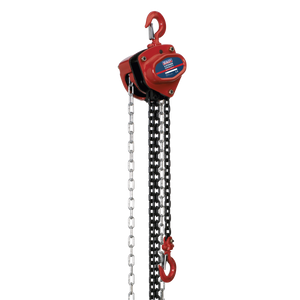 The Sealey Chain Block 0.5 tonne 2.5m - CB500 is a red manual chain hoist featuring a metal chain and two hooks, with one hook attached at the top and another at the bottom, used for lifting and lowering heavy loads. It is equipped with a mechanical load brake for enhanced safety and durability.