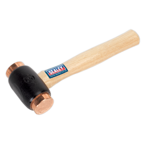 The Sealey Copper Faced Hammer 4.3lb Hickory Shaft - CFH04 is a professional-grade tool featuring a hickory handle with a blue and red Sealey logo sticker, and a black head equipped with pure electrolytic copper faces. Ideal for professional use, this hammer stands out as an excellent choice among Premier Hand Tools.