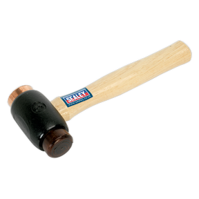 A hammer with a Hickory shaft and a black mallet head featuring the Sealey logo on the side, complemented by Premier Hand Tools quality, specifically the Copper/Rawhide Faced Hammer 3.5lb - CRF35.