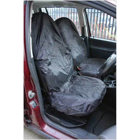 A red vehicle interior featuring Sealey's Front Seat Protector Set 2pc Lightweight - CSC5 on the front seats, made with water-resistant nylon. The opened car door offers a glimpse of the dashboard and steering wheel, emphasizing comprehensive vehicle interior protection.