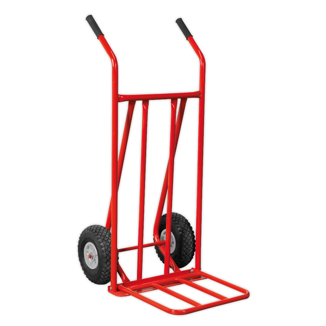 The Sealey Sack Truck with Pneumatic Tyres Folding 150kg Capacity - CST800, featuring a robust metal frame and two black pneumatic tyres, is ideal for navigating rough terrain or uneven surfaces.