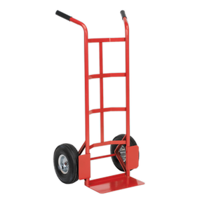 The Sealey Sack Truck with Pneumatic Tyres 200kg Capacity - CST986 is a red and black hand truck with a tubular steel frame, featuring two large black pneumatic tyres and a flat base for lifting and transporting items.