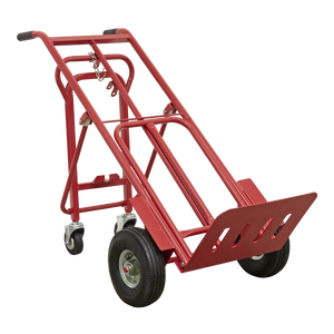 The Sealey Sack Truck 3-in-1 with Pneumatic Tyres (CST989) boasts a 250kg capacity and features a red color, four wheels, a foldable toe plate, and heavy-duty pneumatic tyres, specifically designed for transporting bulky or heavy items.