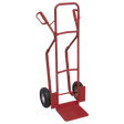 The Sealey Sack Truck with Pneumatic Tyres 300kg Capacity - CST999 is a red hand truck equipped with two black pneumatic wheels and a robust metal frame, designed to assist in moving heavy objects. Ideal for uneven surfaces, it features air-filled pneumatic tires that provide smoother handling over rough terrain.