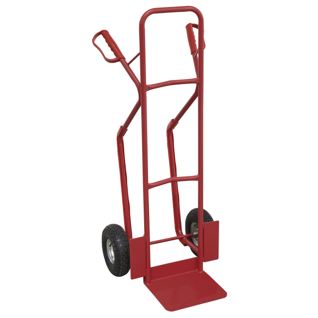 The Sealey Sack Truck with Pneumatic Tyres 300kg Capacity - CST999 is a red hand truck equipped with two black pneumatic wheels and a robust metal frame, designed to assist in moving heavy objects. Ideal for uneven surfaces, it features air-filled pneumatic tires that provide smoother handling over rough terrain.