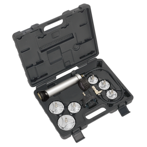 The Sealey Cooling System Pressure Test Kit 7pc - Commercial - CV0011 is a black plastic carrying case tailored for commercial vehicles, containing various cylindrical tools and attachments, including a metallic pump-like device, all neatly arranged in molded compartments. This kit is essential for maintaining the cooling system of heavy-duty engines.