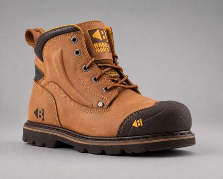 A brown suede work boot with a dark brown protective toe cap and a black lug sole, shown from a three-quarters angle on a neutral gray background.
