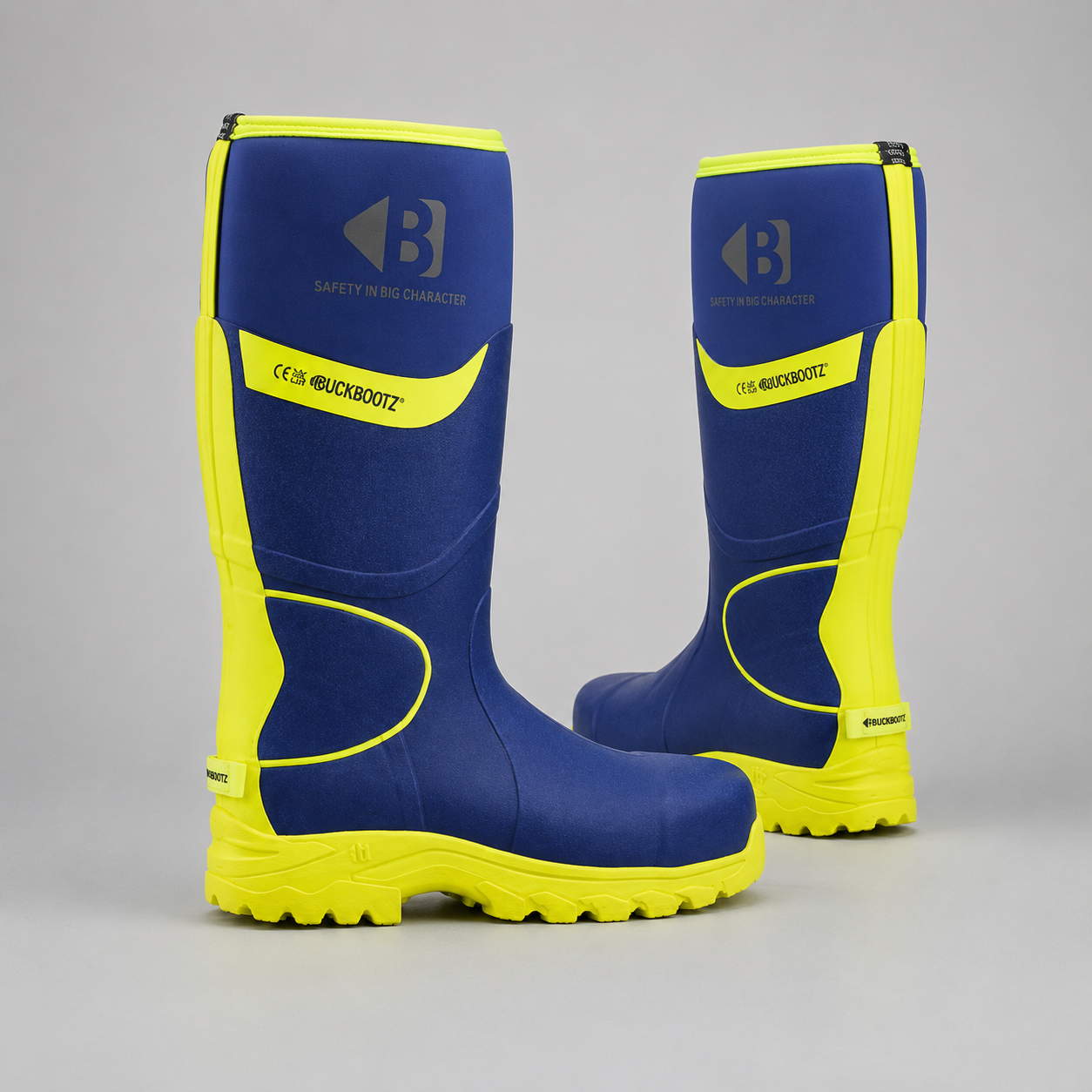 A pair of blue and neon yellow rubber safety boots with the brand name 'Blackroute' and logo visible on the side, set against a neutral gray background.
