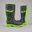 A pair of dark gray and neon green safety boots on a neutral gray background. The boots feature a black and gray upper with bright neon green accents on the collar, side panels, and sole, and a black logo with the text 'B' and 'SAFETY IN RESPONSIBILITY' on the front.