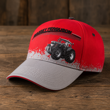 A red and gray baseball cap featuring a black and white graphic of a tractor and the text 'BARRY FERGUSON' on the front, displayed on a rustic wooden surface.