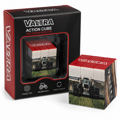 A Valtra action cube puzzle toy shown next to its retail box. The cube is completed and displays a tractor on a green field design, with red and white Valtra branding on the top and side.