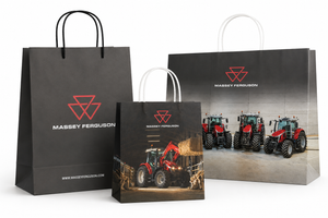 Three Massey Ferguson branded paper shopping bags in different sizes, displayed against a clean white background. The bags feature the red Massey Ferguson logo and brand name, with one larger bag showing a photo of red and blue tractors.