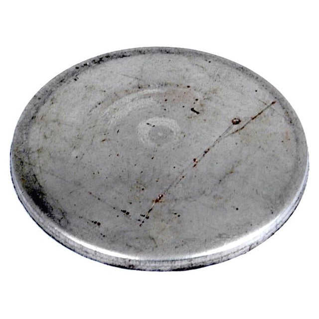 A close-up image of a round, flat metal disc with a scratched surface, possibly indicating it's a Sparex Core Plug - 1 1/4'' (Dished Type - Mild Steel), Part No. S.19174.