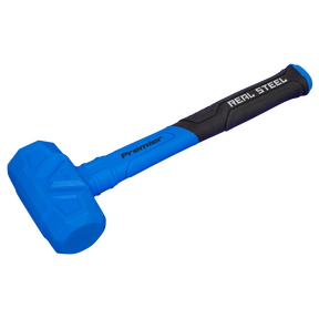 A blue and black Dead Blow Hammer 1.75lb - DBH01 from Sealey with the text "Real Steel" on the handle, featuring a dual-layer molded grip, a flat striking surface, and a soft grip handle.