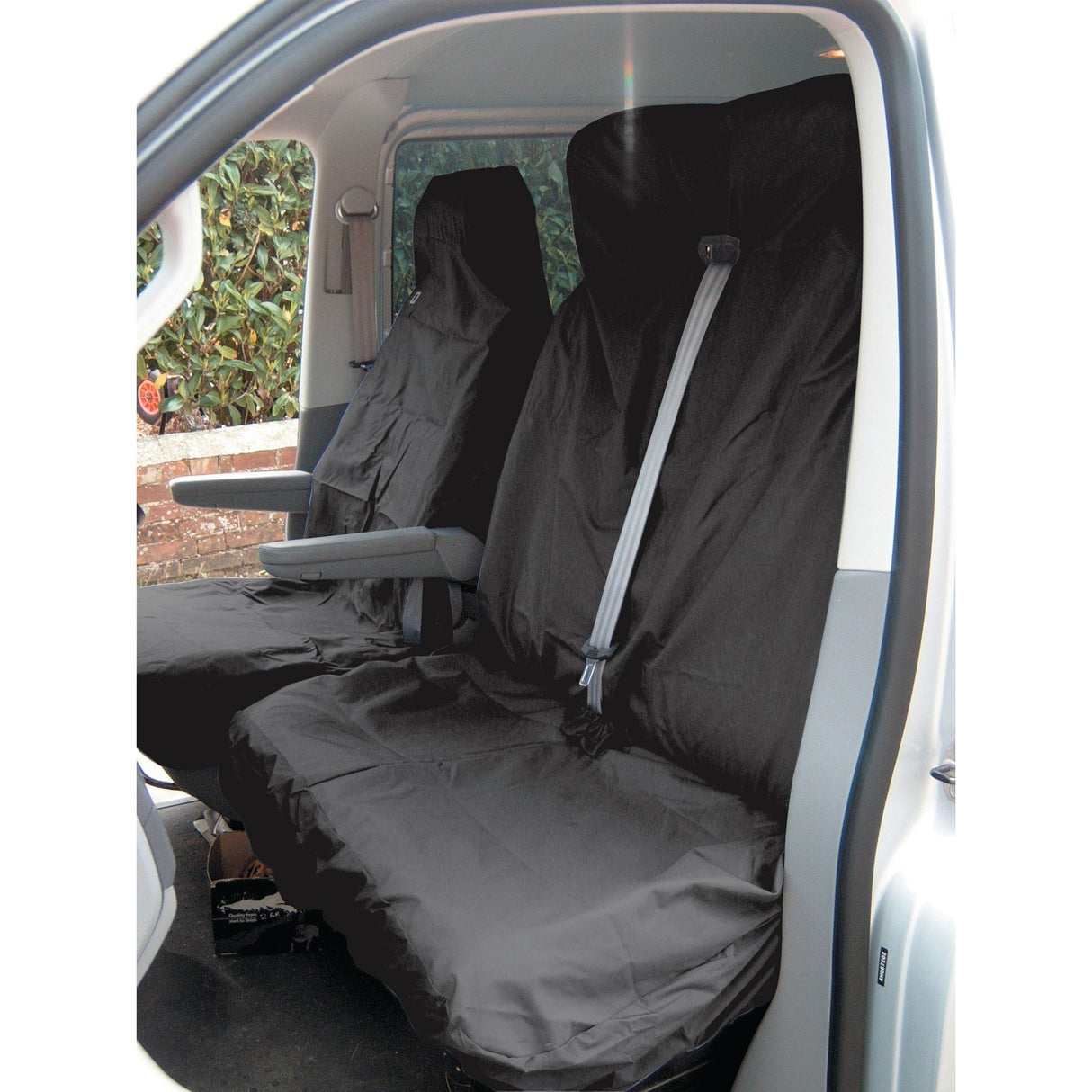 A vehicle interior featuring the Sparex Double Passenger Seat Cover - Van - Universal Fit - S.71713, with black waterproof and washable protective covers on both the driver and passenger seats.