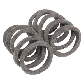 A scattered pile of Dust Seal - Felt gaskets (Sparex Part No. S.41570), ideal for use as dust seals or replacement components in Massey Ferguson machinery.