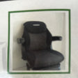 Image of an AGCO Fendt - Seat Cover - X991450003000, a black ergonomic chair with armrests and a padded seat featuring an adjustable cushion, framed in a green border.