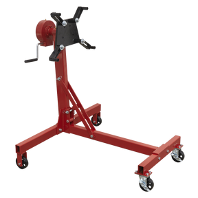 The Sealey Folding 360º Rotating Engine Stand with Geared Handle Drive (model ES480D), a red stand designed to support up to 450kg, features adjustable arms, caster wheels, and a hand crank for facilitating full engine rotation during maintenance.