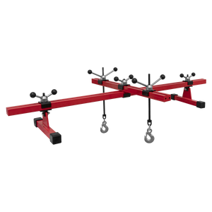 The Sealey Engine Support Beam with Cross Beam 500kg Capacity (model ES601) is a red engine support bar featuring an adjustable rotating beam, hooks, and stabilizing feet designed for securing and positioning engines during vehicle maintenance.