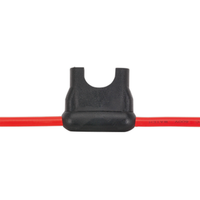 Close-up of the Sealey Standard Blade Fuse Holder 30A (model FH30), featuring a black body and red wire leads on both sides, designed for a 30A standard blade fuse.