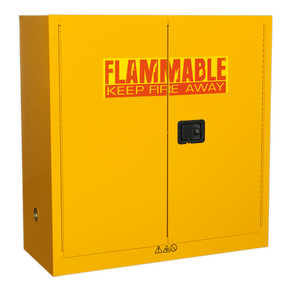The Sealey Flammables Storage Cabinet FSC09, measuring 1095 x 460 x 1120mm, comes in yellow with a black handle and is marked with the warning text “FLAMMABLE KEEP FIRE AWAY” in red and yellow on the doors. Featuring a sturdy metal construction and an adjustable lipped shelf, it ensures the safe storage of flammables.