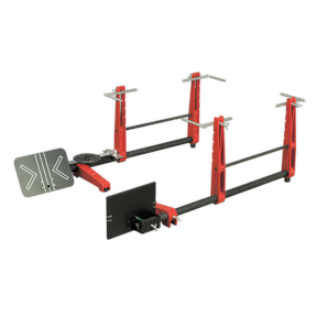 A red and black adjustable squat and bench press rack featuring safety arms, weight holders, and the Sealey Laser Wheel Alignment Gauge - GA50 for precise setup.