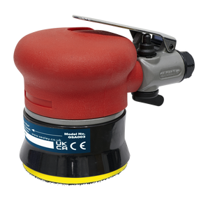 A red, handheld Air Palm Orbital Sander with a Ø75mm black and yellow hook-and-loop sanding pad and metal control lever is shown. The label indicates it is a Sealey model GSA003 with UKCA and CE certifications. The tool features variable speed control for quick adjustment in various tasks.