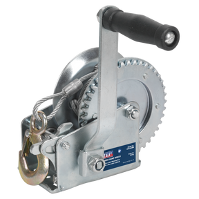 The Geared Hand Winch 540kg Capacity with Cable - GWC1200M by Sealey features a crank handle, steel cable, and hook, along with a hardened steel label on the side. Perfect for recovery operations.