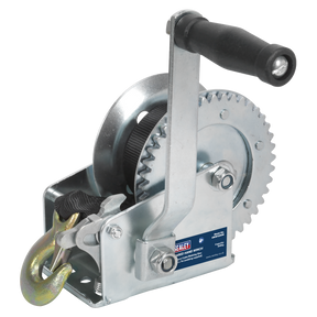 The Sealey Geared Hand Winch 540kg Capacity with Webbing Strap - GWW1200M features a crank handle, steel gear mechanism, and hook, commonly used for lifting or pulling heavy loads in recovery operations.